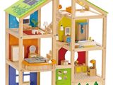 wooden doll house with solar panels on the roof and windows