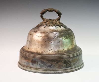 a silver bell with a ring on top of it
