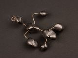 a close up of a bunch of black glass beads on a black surface