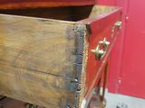 a wooden dresser with a drawer on top of it