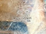 a close up of a silver plate with writing on it