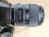 a camera with a lens attached to it ' s body