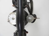 a close up of an old sewing machine with a cord
