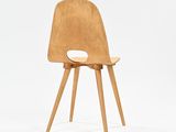 the chair is made out of wood and has a wooden seat