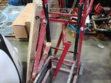 a picture of a red and black ladder in a warehouse
