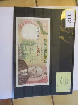 une photo d'un billet sur lequel figure l'image d'un homme
