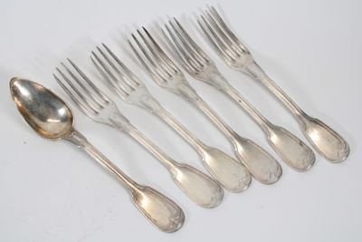 six forks and a spoon on a white table