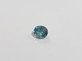 a close up of a blue diamond on a white surface