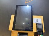 a tablet and a cell phone sitting on a stand