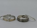 pair of silver and gold rings on a white background