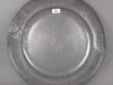 a silver plate with a label on it on a table