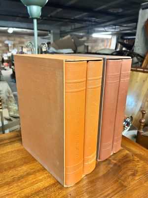 three books that are sitting on a wooden table