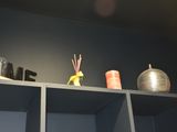 a shelf with candles, candles, and vases on it