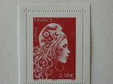 the stamp is red and white with a woman ' s face on it