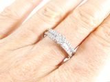 a woman ' s hand with a diamond ring on it