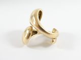 a close up of a gold ring on a white surface