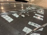 a reflection of a building on the windshield of a car