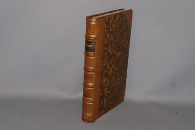 a brown book sitting on top of a white table