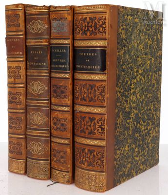 three books are stacked on top of each other on a white surface