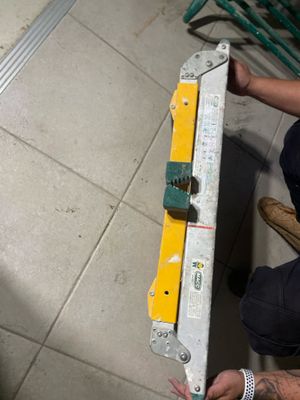 a man that is holding a tool in his hand
