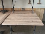 a wooden table with metal legs and a wooden table top