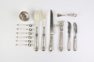 many different types of silverware on a white surface