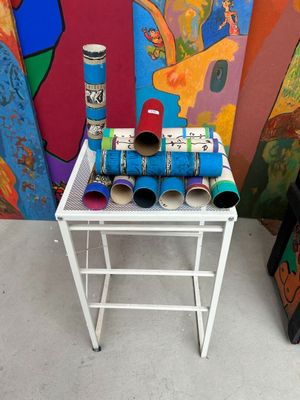 a small table with a bunch of rolls of toilet paper on it