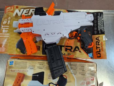 a nerf gun on a table next to a package of nerf guns