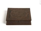 an old wooden box sitting on top of a white surface