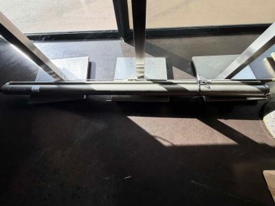 a gun that is laying on the floor next to a window
