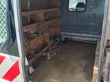 a van that has a bunch of crates in the back of it