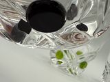 a glass vase with a flower in it on a table