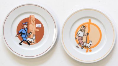 two plates with pictures of a man and a dog on them