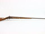 a rifle with a wooden barrel on a white background