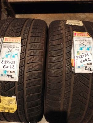 two tires with stickers on them are on display in a store