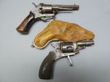two revolvers that are sitting next to each other on a table