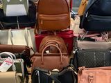 a lot of purses on a table in a store
