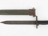 pair of old and rusty knifes on a white surface
