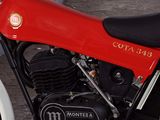 a red and black motorcycle parked on the side of the road