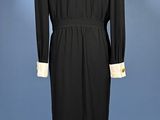 a black dress with white collar and cuffs on a mannequin mannequin mannequin mannequin mannequin mannequin mannequin mann