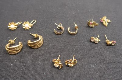 a close up of a bunch of earrings on a table
