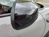 a reflection of a person in the side mirror of a car