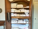 a closet with a bed and a dresser in the room