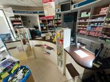 an image of a pharmacy shop with a counter and shelves