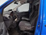 the interior of a blue van with the door open and the driver ' s seat down