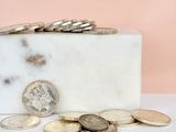 a marble block with a bunch of coins on it