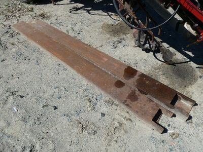 a piece of wood laying on the ground next to a bike