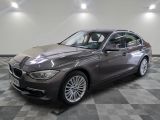 an image of a grey bmw car in a showroom