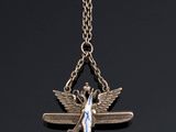 a silver necklace with an angel and a blue ribbon on a chain