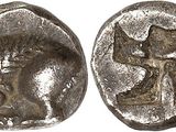 a silver coin with an image of a man and a cross on it
